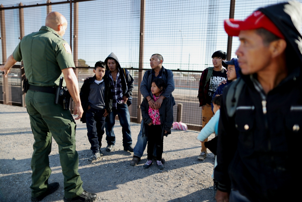 A group of Central American migrants is questioned about their children's health after surrendering to U.S. Border Patrol agents south of the U.S.-Mexico border fence in El Paso, Texas, March 6. (CNS/Reuters/Lucy Nicholson) A group of Central American migrants is questioned about their children's health after surrendering to U.S. Border Patrol agents south of the U.S.-Mexico border fence in El Paso, Texas, March 6. (CNS/Reuters/Lucy Nicholson)