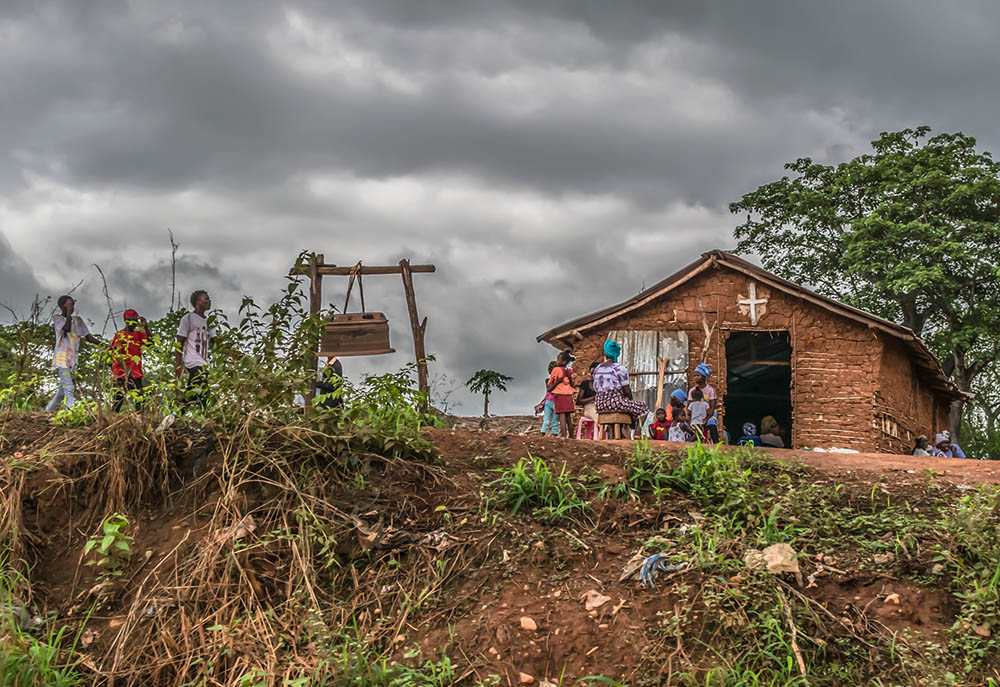 People outside a Catholic church in a village in Malanje Province, Angola, in 2018 (Dreamstime/Nuno Almedia)