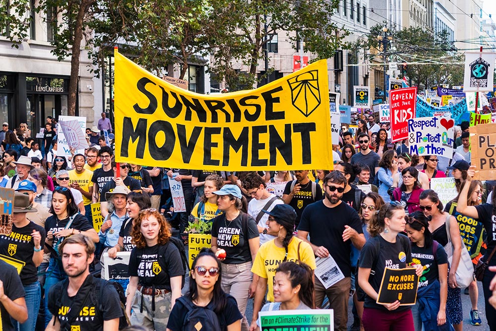 Members of the Sunrise Movement carry placards and banners at the Global Youth Climate Strike Rally and March in San Francisco Sept. 20, 2019. (Dreamstime/Andreistanescu)