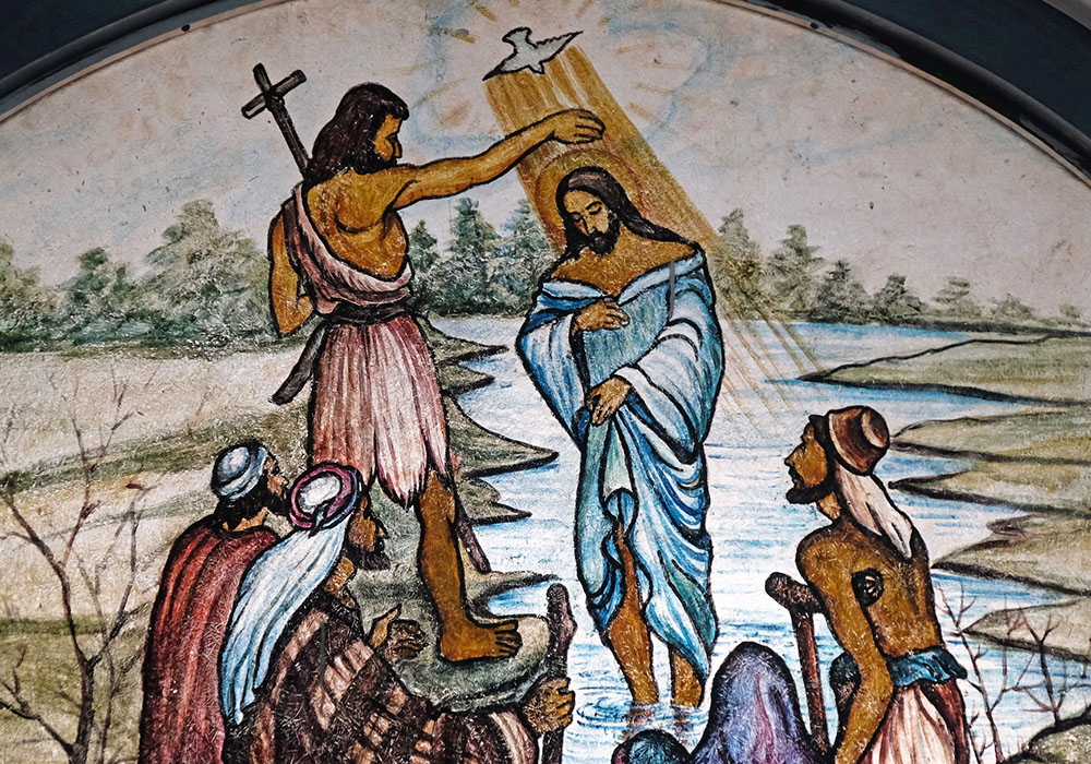 The baptism of the Lord is depicted in stained glass at the Cathedral of Immaculate Heart of Mary and St. Teresa of Calcutta in Baruipur, West Bengal, India. (Dreamstime/Zatletic)