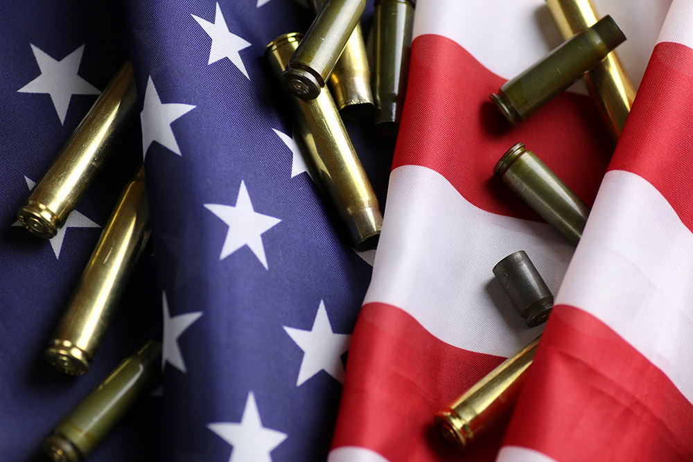 American flag and bullet casings (Dreamstime/Aleksandr Kichigin)