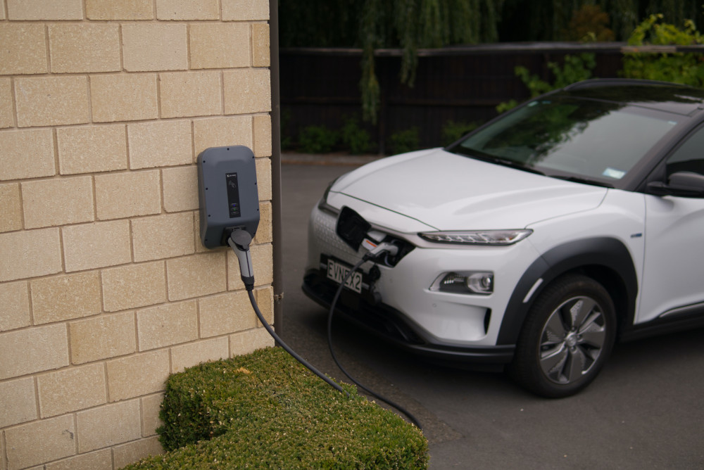 A Hyundai Kona charging at an Evnex charging station in New Zealand. (Unsplash/Ed Harvey)