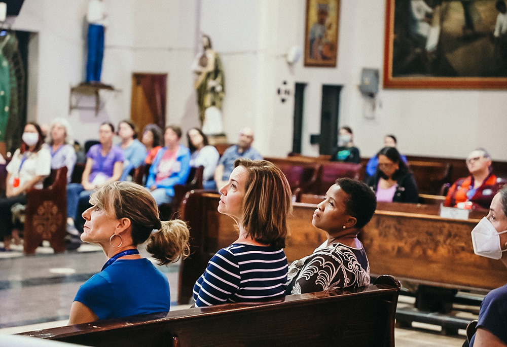 Patricia Santos of St. Paul, Minnesota, Carmen Villafañe of Miami, and Philomene Peán from Boston listen to preaching during the closing liturgy at the Church of the Fifth Apparition, Santa Maria Tulpetlac, during Discerning Deacons' pilgrimage to Mexico.