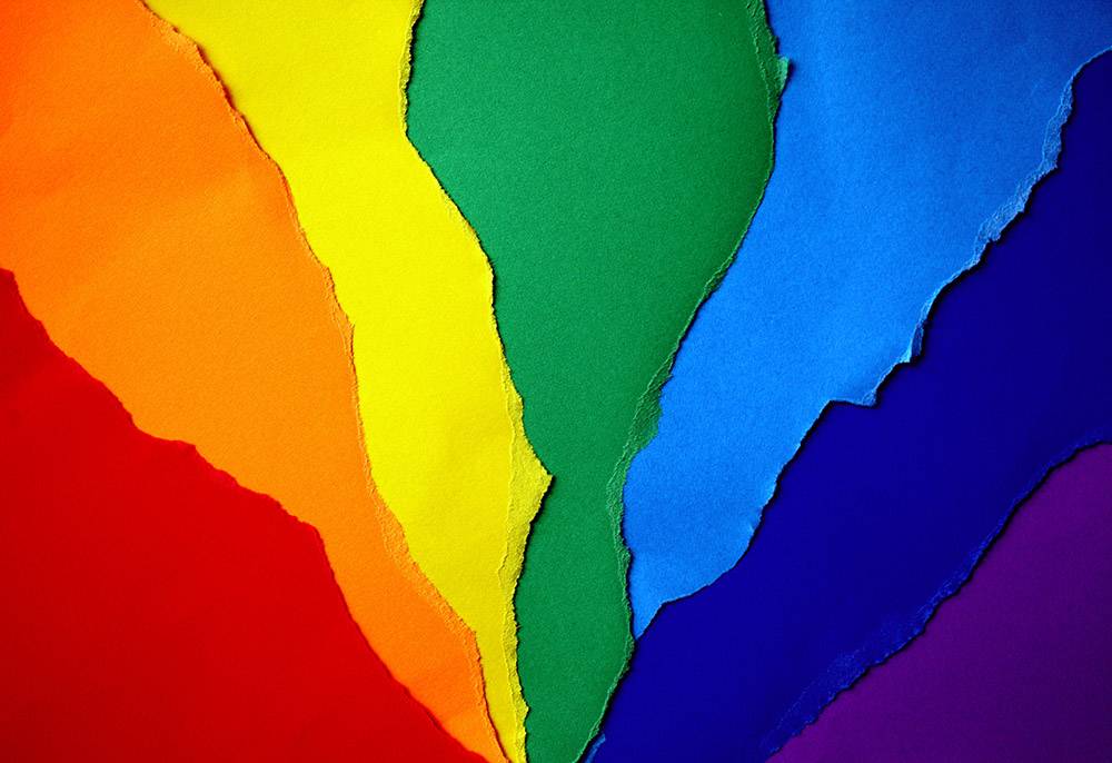 Rainbow flag in construction paper (Unsplash/Katie Rainbow)