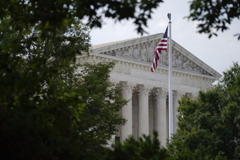 An American flag waves in front of the U.S. Supreme Court building, June 27, 2022, in Washington. (AP/Patrick Semansky)