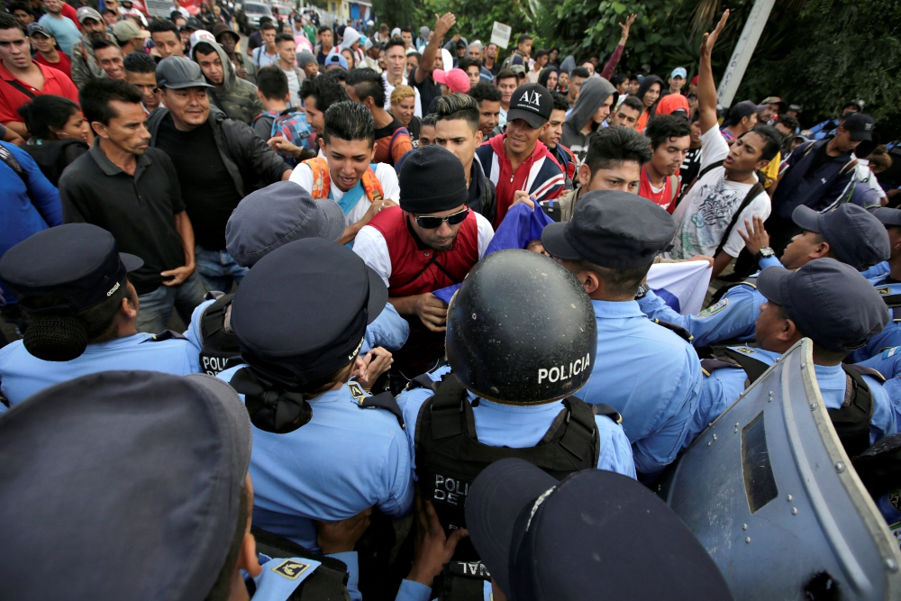 Trying to join a caravan headed to the U.S., migrants scuffle with police at the border with Guatemala Oct. 19, 2018, in Ocotepeque, Honduras. (CNS/Reuters/Jorge Cabrera)