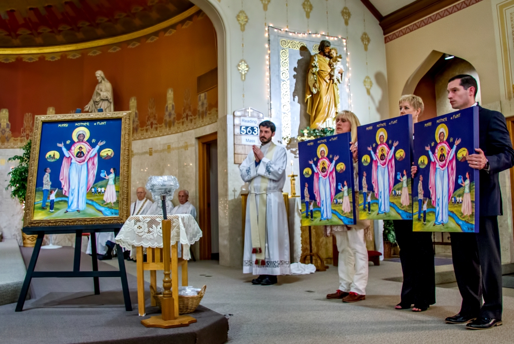 Members of the Catholic Community of Flint in Michigan present an icon of Mother, Mary of Flint at St. Mary Church, along with replicas to be placed in the three other churches of the community on Mother's Day, May 13. (Gary Pearce)