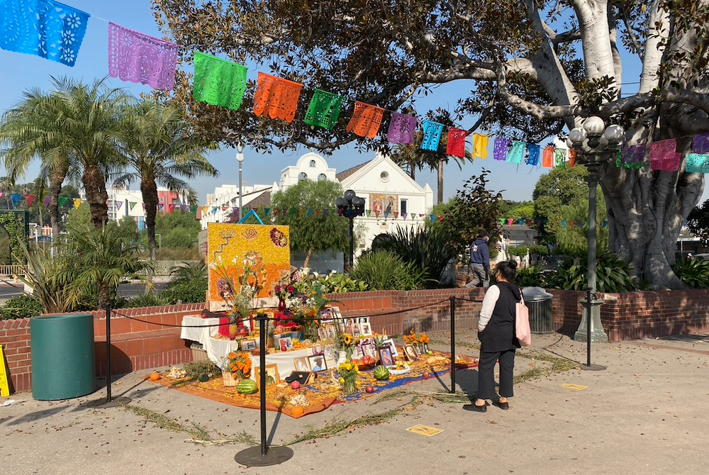 A woman looks at one of the "ofrendas" in Los Angeles Plaza Oct. 23, adjacent to Olvera Street. (NCR photo/Lucy Grindon)