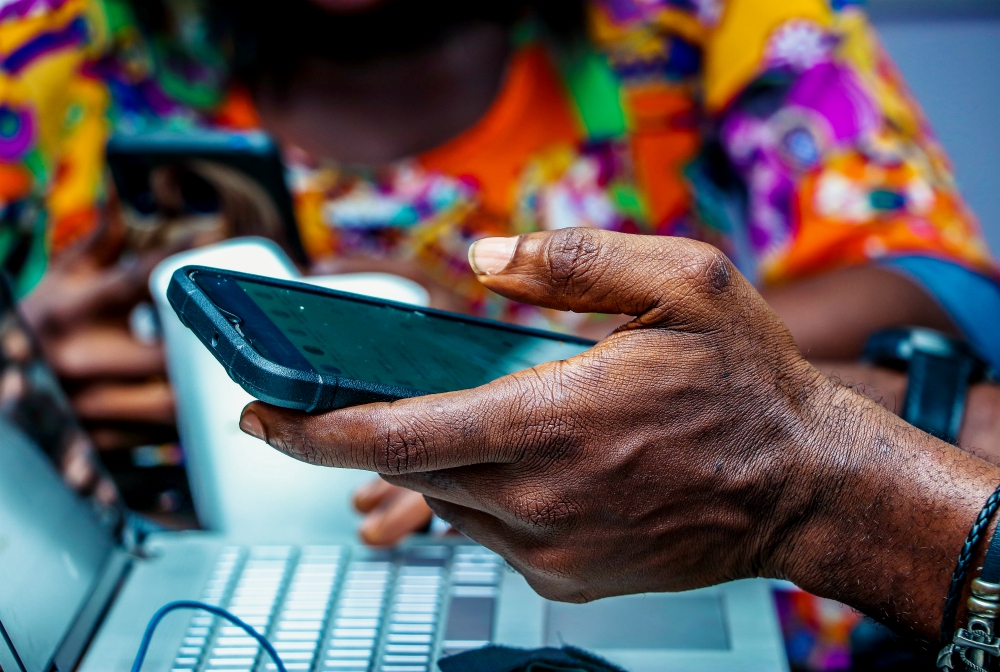 A man holds a cellphone in Lagos, Nigeria. (Unsplash/Olumide Bamgbelu)