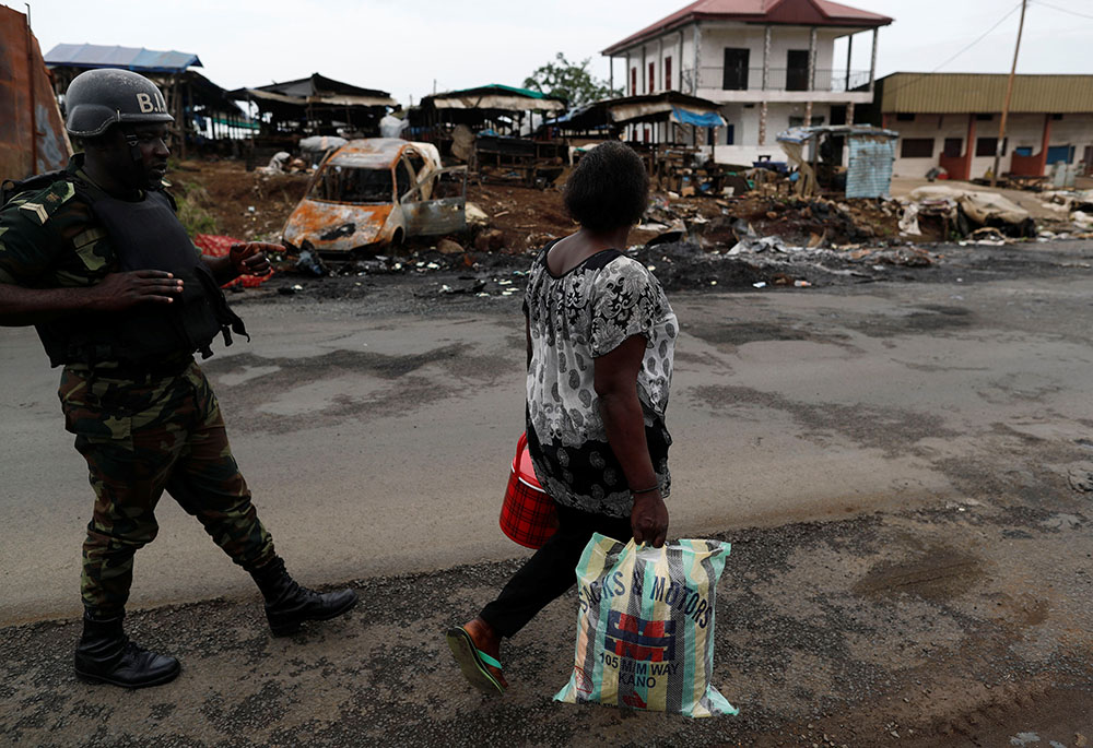 A woman walks past a soldier of the Cameroon army's elite Rapid Intervention Battalion in the city of Buea in the Anglophone Southwest Region Oct. 4, 2018. (Newscom/Reuters/Zohra Bensemra) A woman walks past a soldier of the Cameroon army's elite Rapid Intervention Battalion in the city of Buea in the Anglophone Southwest Region Oct. 4, 2018. (Newscom/Reuters/Zohra Bensemra)