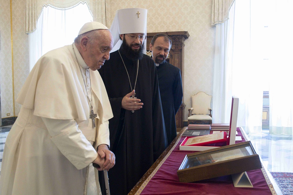 Pope Francis exchanges gifts with Metropolitan Anthony of Volokolamsk, head of external relations for the Russian Orthodox Church, during a meeting at the Vatican Aug. 5, 2022.