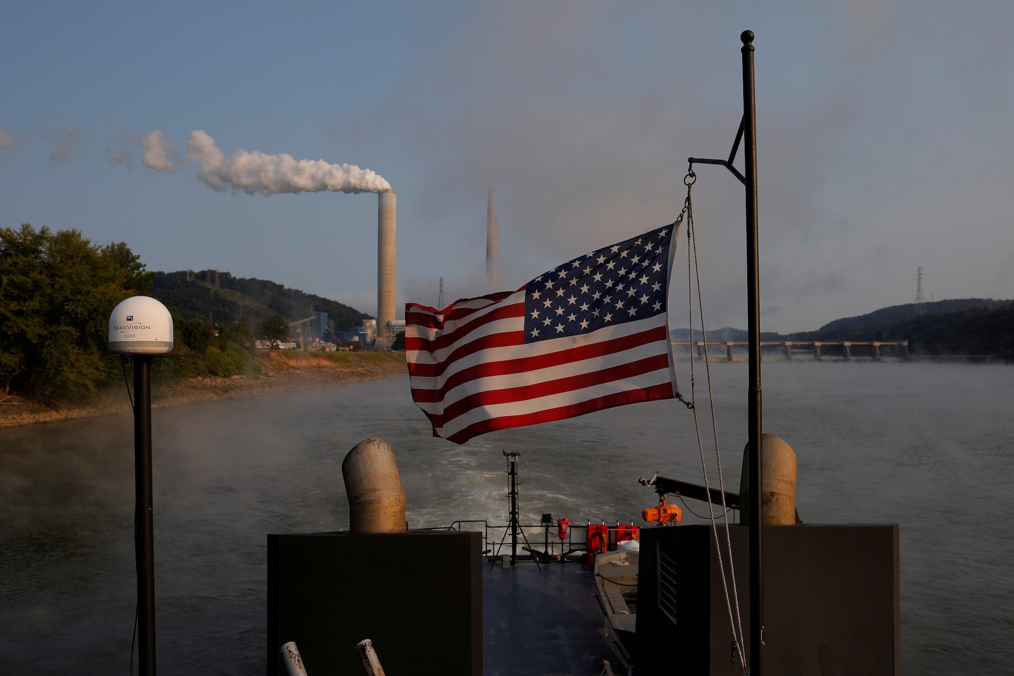 A towboat passes a coal-fired power plant along the Ohio River in Stratton, Ohio, in 2017. (CNS photo/Brian Snyder, Reuters)