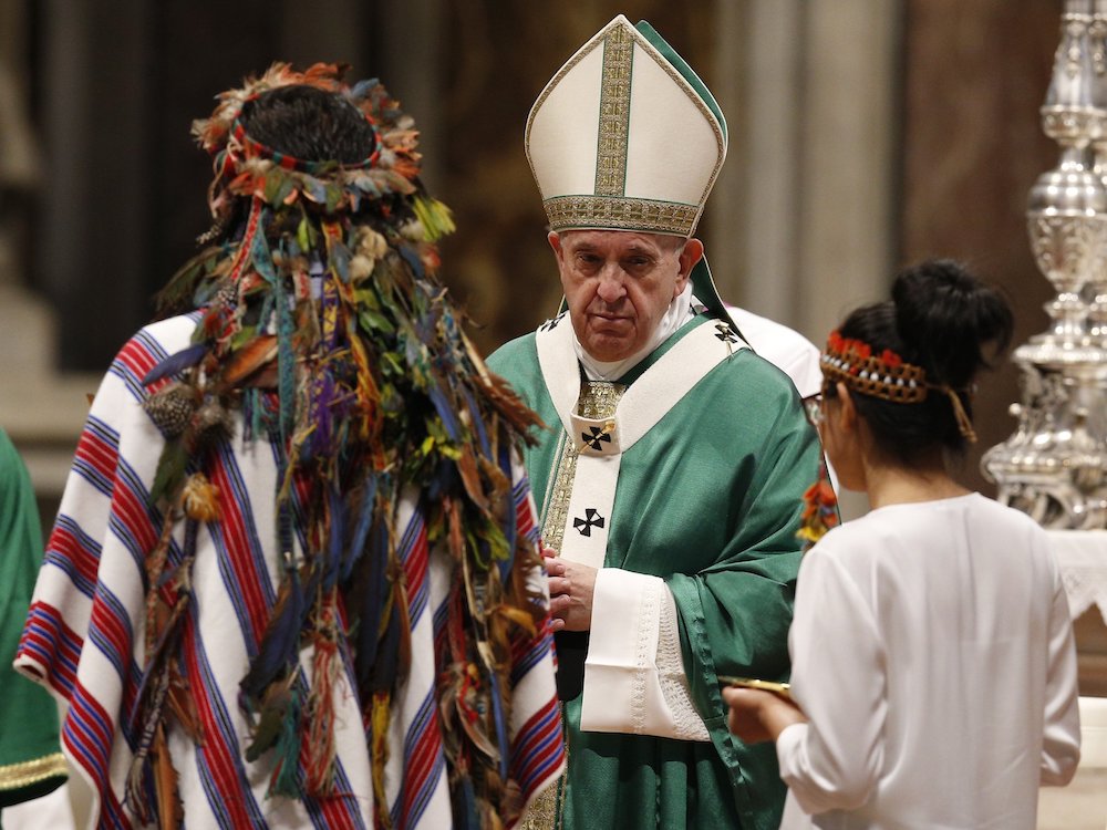 Pope Francis accepts offertory gifts from Indigenous people as he celebrates the concluding Mass of the Synod of Bishops for the Amazon at the Vatican on Oct. 27, 2019. (CNS photo/Paul Haring) 