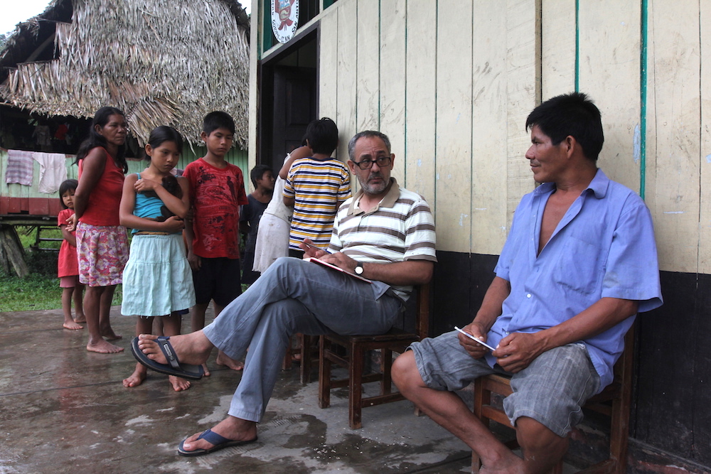 Then-Fr. Miguel Angel Cadenas talks with a community member in the village of San Antonio de Bancal, on the remote Urituyacu River in Amazonian Peru, during an annual visit in 2014. (Barbara Fraser)