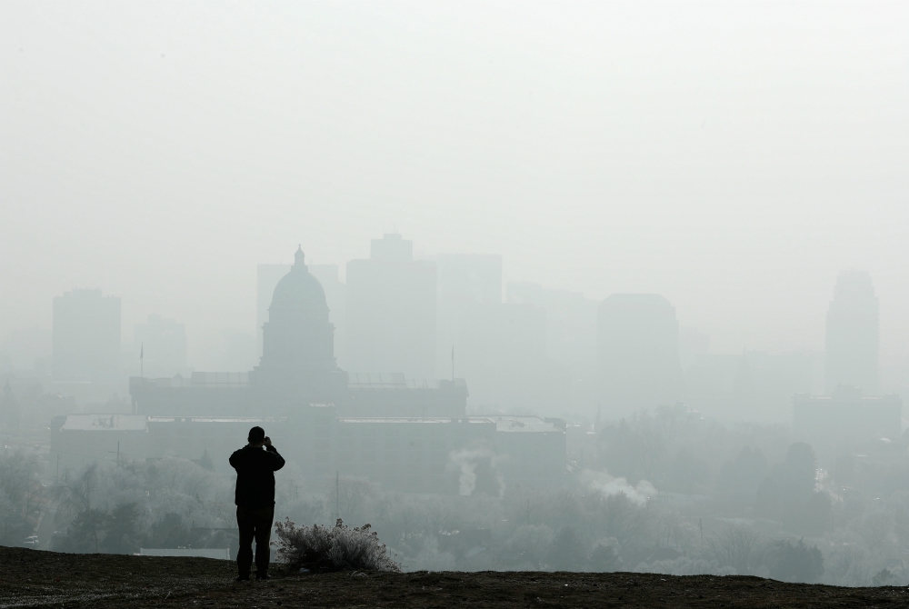 A man stops to take a picture of the Utah State Capitol and buildings that are shrouded in smog in downtown Salt Lake City Dec. 12, 2017. (CNS/Reuters/George Frey) A man stops to take a picture of the Utah State Capitol and buildings that are shrouded in smog in downtown Salt Lake City Dec. 12, 2017. (CNS/Reuters/George Frey)