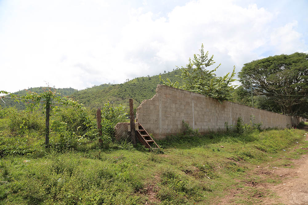 A crumbling, half-finished fence runs through a section of Yorito. Initially meant to encircle a nearby soccer field, funds for the fence vanished in what residents say is one small example of the deleterious effects of corruption on the nation.