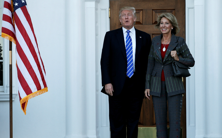 President-elect Donald Trump stands with Betsy DeVos after their meeting at the main clubhouse at Trump National Golf Club in Bedminster, N.J., on Nov. 19, 2016. (Reuters/Mike Segar)