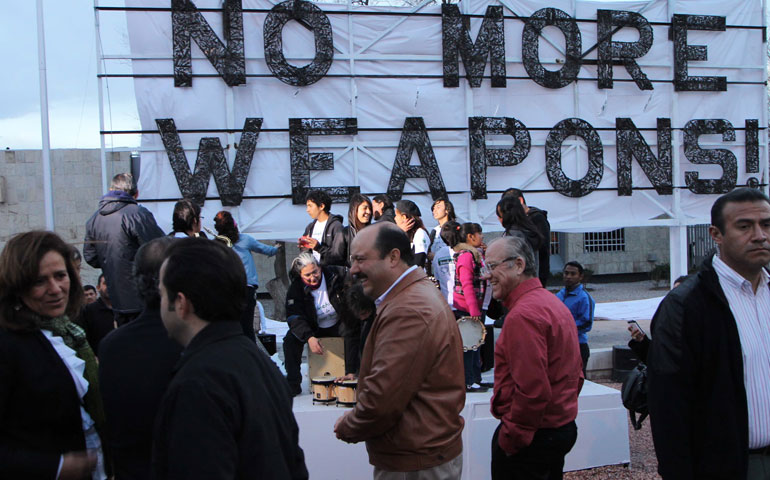 Mexican President Felipe Calderón inaugurates a billboard near the border of the United States with the message "No more weapons" on Feb. 16, 2012. (Newscom/Getty Images/AFP/Jesus Alcazar)