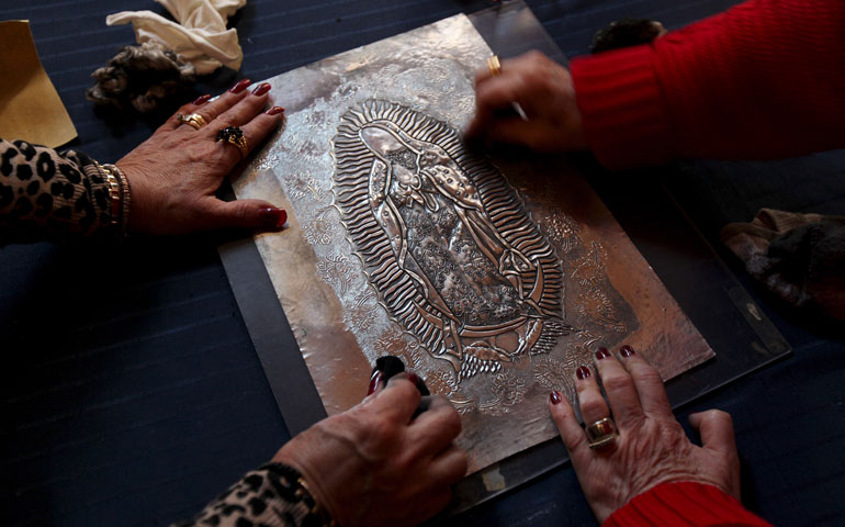 On Jan. 27, craftswomen polish an image of the Virgin of Guadalupe embossed in a sheet of tin that will be used as the cover of a Book of the Gospels commissioned for the visit of Pope Francis to Ciudad Juárez, Mexico. (Newscom/Reuters/Jose Luis Gonzales)