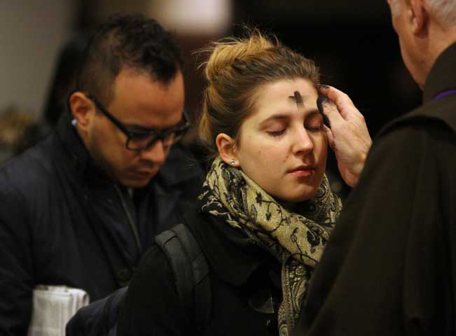 A woman receives ashes on Ash Wednesday at St. Francis of Assisi Church in New York March 5, 2014. (CNS photo/Long Island Catholic/Gregory A. Shemitz)