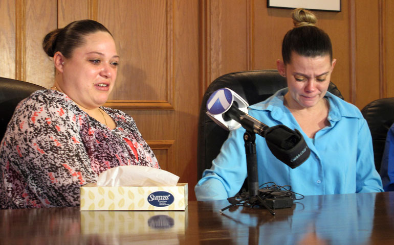 Amber McGuire, left, recounts the execution of her father, Dennis McGuire, as her sister-in-law, Missie McGuire, cries at a news conference Jan. 17 in Dayton, Ohio. (AP Photo/Kantele Franko)