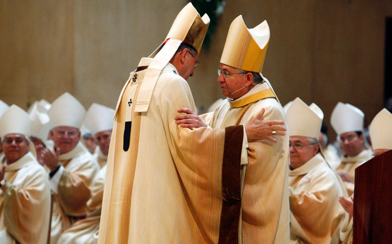 Cardinal Roger Mahony, left, embraces Archbishop Jose Gomez during a May 26, 2010, Mass of reception for Gomez as the new coadjutor archbishop of Los Angeles. (CNS)