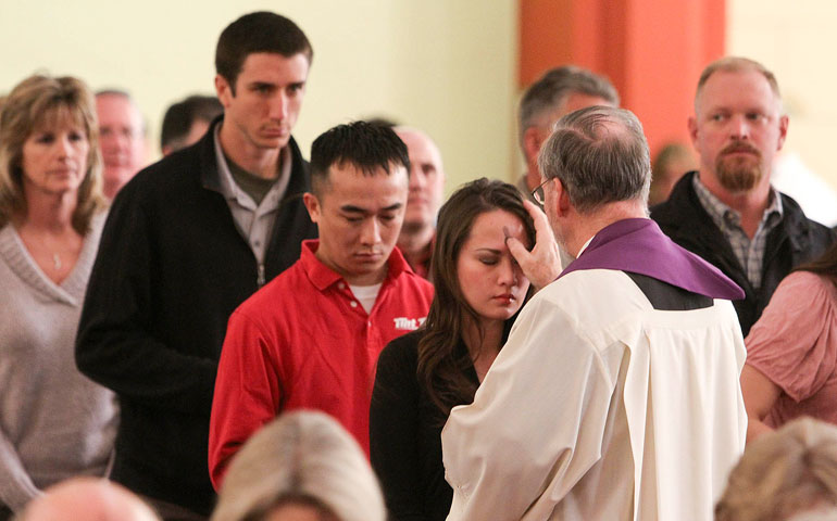 A woman receives ashes from Msgr. Gregory Gier, rector of Holy Family Cathedral in Tulsa, Okla., during a 2012 Ash Wednesday service. (CNS/Eastern Oklahoma Catholic/Dave Crenshaw)