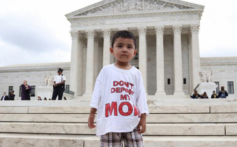 A boy wearing a T-shirt reading "Don't Deport My Mom" stands outside the U.S. Supreme Court in Washington June 23 after the justices issued a 4-4 ruling on President Barack Obama's executive actions on immigration. (CNS/Andrew Gombert, EPA)