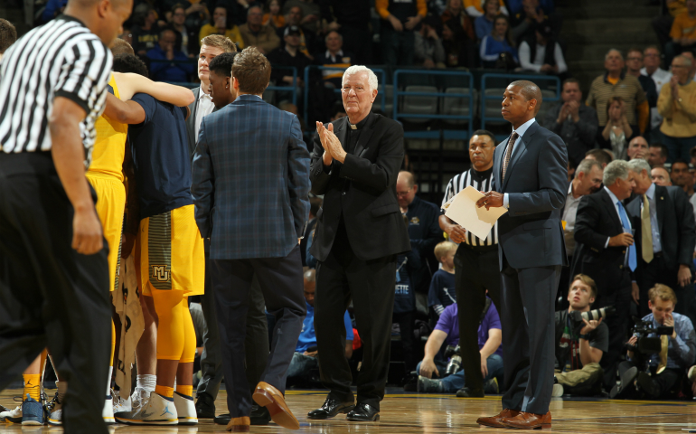 Jesuit Fr. John Laurance, chaplain of the Marquette University men's basketball team, during a timeout at a recent game. Father Laurance is in his second year as team chaplain. (Marquette University/Maggie Bean)