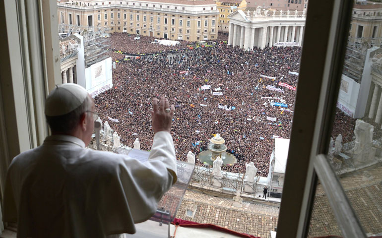 Pope Francis waves to the crowd as he leads his first Angelus in St. Peter's Square at the Vatican March 17, 2013. (CNS/L'Osservatore Romano)