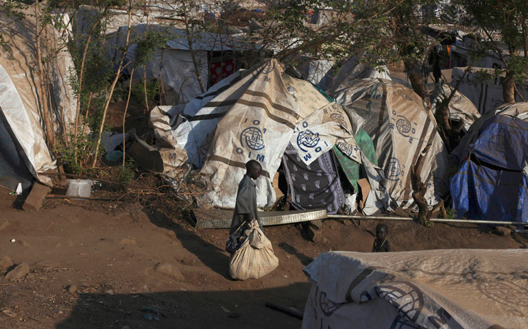 Children walk past tents in one of the two U.N. mission compounds that are holding displaced people in Juba, South Sudan, Jan. 27. (CNS/Reuters/Andreea Campeanu)