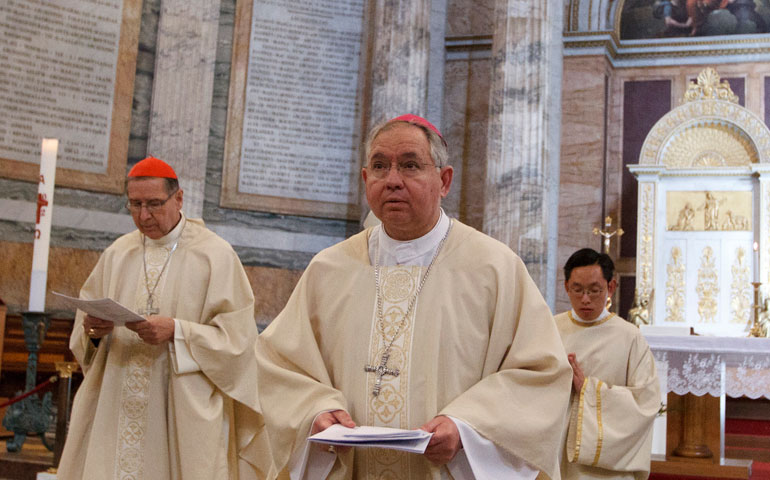 At the Basilica of St. Paul Outside the Walls in Rome, Cardinal Roger Mahony, left, and Archbishop Jose Gomez walk in procession after concelebrating Mass with other U.S. bishops making “ad limina” visits to the Vatican in April 2012. (CNS/Paul Haring)