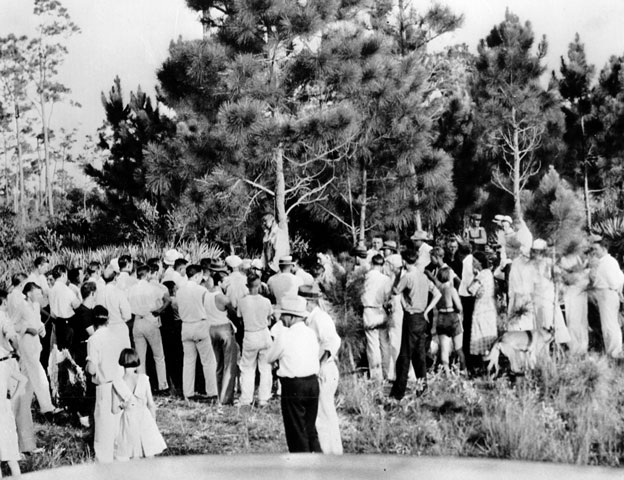 A crowd gathers to view the body of 32-year-old Rubin Stacy as he hangs from a tree in Fort Lauderdale, Fla., on July 19, 1935. Stacy was lynched by a mob of masked men who seized him from the custody of sheriff's deputies for allegedly attacking a white woman. (AP Photo)
