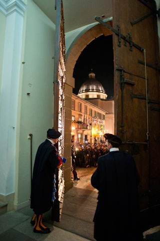 Members of the Swiss Guard close the main door of the papal villa at Castel Gandolfo, Italy, at 8 p.m. Feb. 28. The Swiss Guard concluded its protective service to Pope Benedict XVI, signaling the end of his papacy. (CNS/Reuters/L’Osservatore Romano)