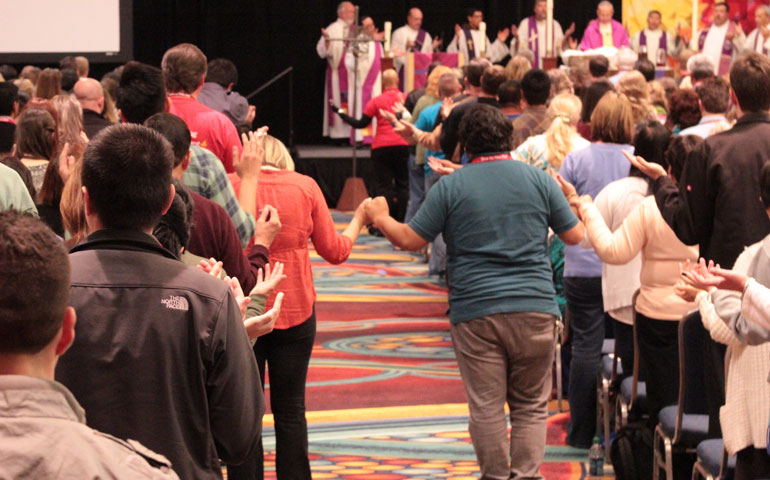 Conference attendees gather for the Our Father at the Saturday evening young adult Mass Feb. 23 at the Los Angeles Religious Education Congress. (James Dean Esparza)