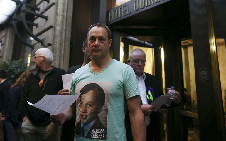 In Rome Feb. 28, Peter Blenkiron, center, a child sex abuse victim, looks on in front of the Hotel Quirinale, where Cardinal George Pell testified via video link to Australia’s Royal Commission into Institutional Responses to Child Sexual Abuse in Sydney. Blenkiron’s T-shirt features a picture of himself when he was young. (CNS/Reuters/Alessandro Bianchi)