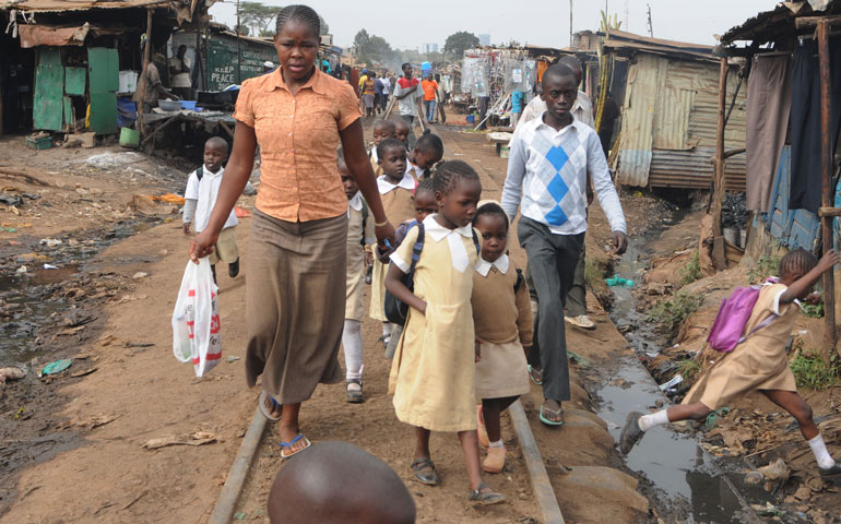People bring their children to school in the Kibera slum of Nairobi, Kenya, June 10, 2013. (Newscom/ZUMA Press/Teun Voeten)