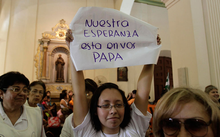 A woman holds a sign that reads: “Our hope is in you, pope,” during a Mass of thanksgiving in honor of Pope Francis at the Metropolitan Cathedral in Asuncion, Paraguay, March 17. (CNS/Reuters/Jorge Adorno)