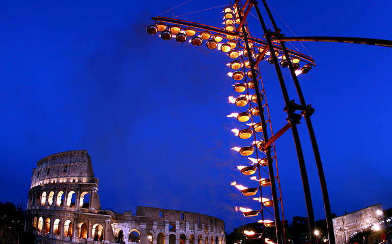 A cross of flames overlooks the ancient Roman Colosseum, believed to be a site of early Christian martyrdom, at the start of the Way of the Cross led by Pope Benedict XVI on Good Friday in 2006. (Newscom/EPA/Ettore Ferrari)
