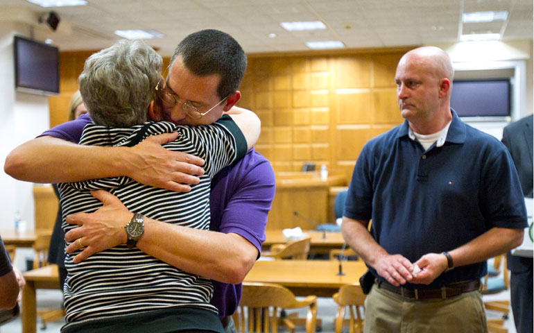 Troy Merryfield embraces his mother Sharon, as his brother Todd Merryfield looks on after a jury found the Green Bay, Wis., diocese responsible for concealing Fr. John Feeney’s history of child molestation on May 21, 2012, at the Outagamie County Justice Center in Appleton, Wis. (AP/The Post-Crescent/Dan Powers)