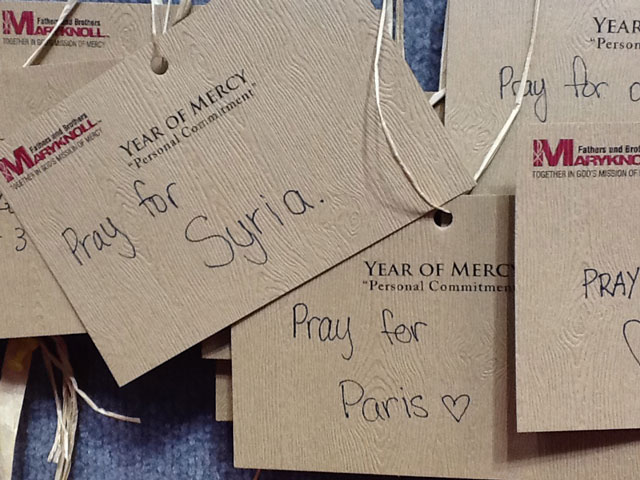Visitors add their mercy prayer cards to the booth of the Maryknoll Fathers and Brothers at the National Catholic Youth Conference in Indianapolis in November 2015. (Photos courtesy of Greg Darr)