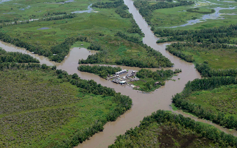 An oil facility is seen in the middle of canals dug for pipelines on the coast of Louisiana in 2010. (AP Photo/Patrick Semansky)