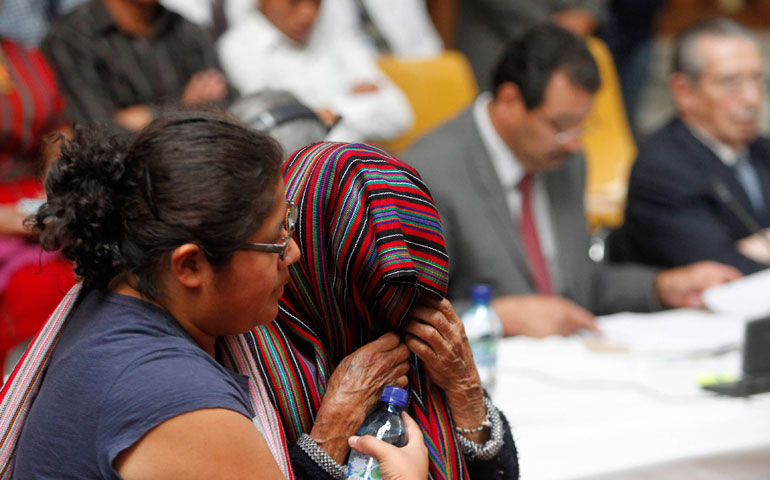 An idigenous woman of Guatemala's Ixil region covers her face as she walks to testify in the trial against Efrain Rios Montt in the Supreme Court of Justice in Guatemala City April 2. (Photos by Reuters/Jorge Dan Lopez)