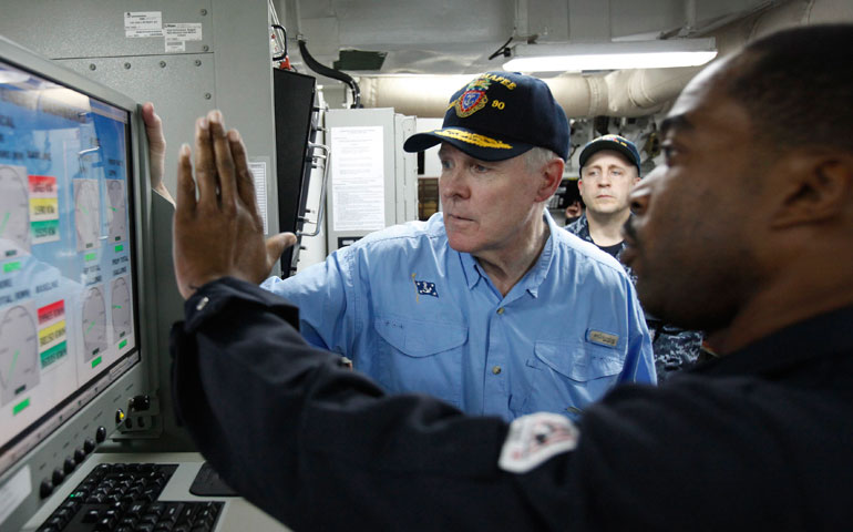 U.S. Secretary of the Navy Ray Mabus listens as Chief Petty Officer Todd Merchant, right, explains how a computer adjusts biofuel consumption aboard the USS Chafee off the coast of Oahu, Hawaii, in 2012. (Newscom/Reuters/Hugh Gentry)