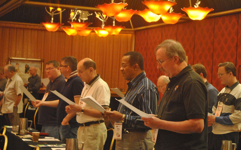 Fr. John Judy of Louisville, Ky., front, second from right, sings an opening prayer with fellow priests April 24 during the 45th annual conference of the National Federation of Priests’ Councils in Reno, Nev. (NCR photos/Brian Roewe)