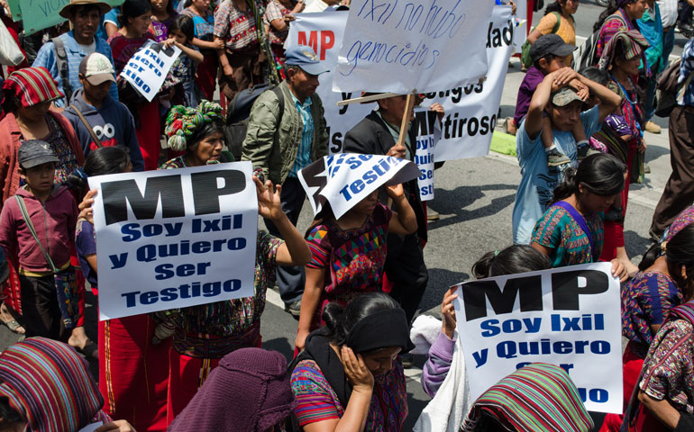 Ixil Maya, including ex-members of paramilitaries, demonstrate in Guatemala City April 23 against the trial of Efraín Ríos Montt, holding signs saying, “I am Ixil and I want to be a witness” and “There was no genocide.” (Werner Monterroso)