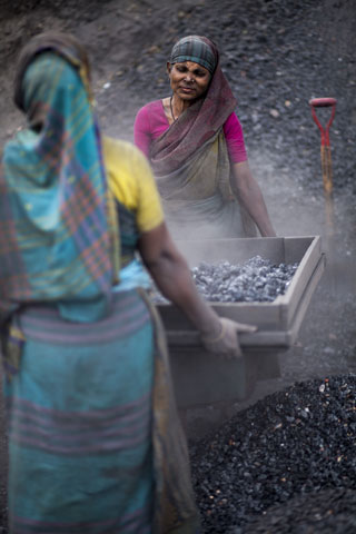 Women work at a waste coal processing site in Munshiganj, Bangladesh, in December. Lung diseases are common among the laborers, who earn about $14 per week. (Zuma Press/Zakir Hossain Chowdhury)