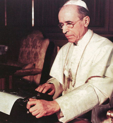 During World War II, Pope Pius XII writes one of his Christmas radio messages using a typewriter at the Vatican in an undated photo. (CNS/Courtesy of Libreria Editrice Vaticana)