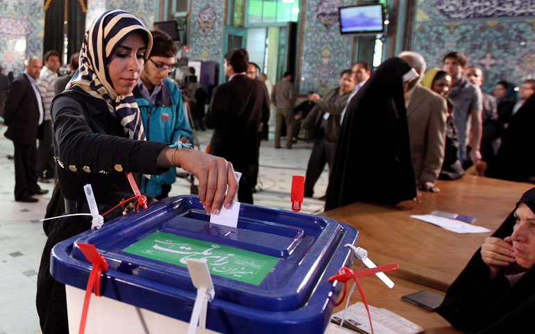 A woman casts her vote at a polling station during parliamentary elections in Tehran, Iran, May 4, 2012. (EPA/Abedin Taherkenareh)