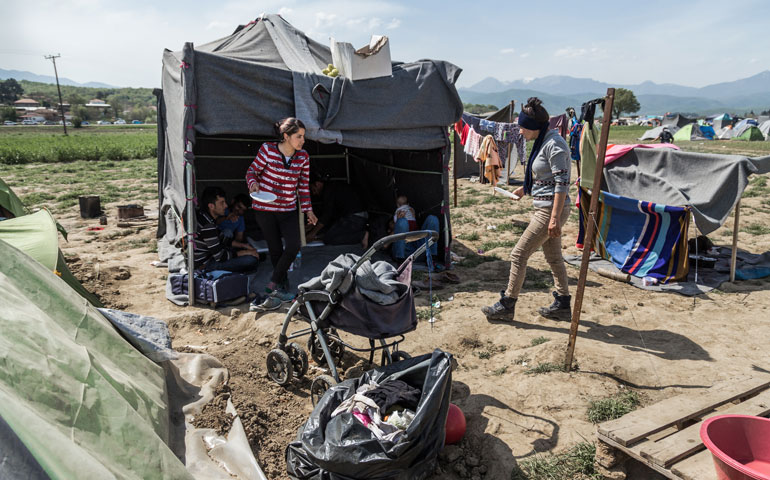 Some Yazidis from different families gather after a meal in April in the informal refugee camp in Idomeni, Greece. (Photos by Giacomo Sini)